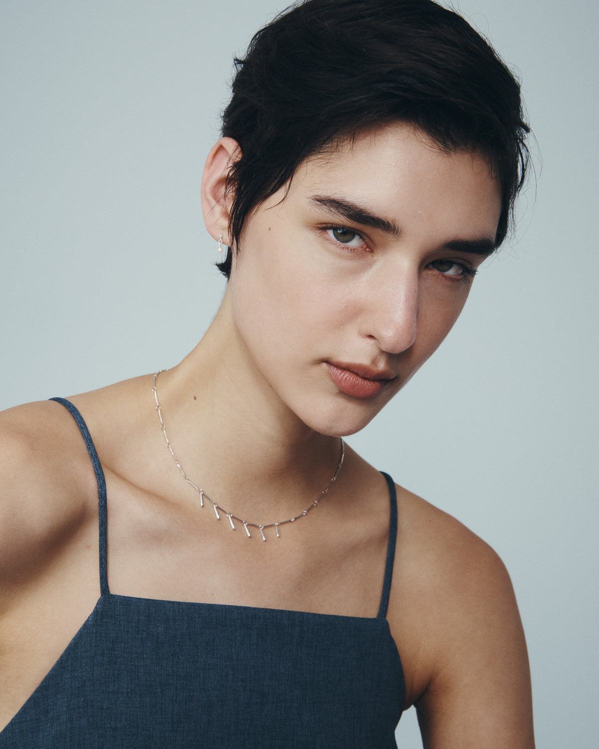 Stilla Necklace and Hydra Earrings in Silver, worn