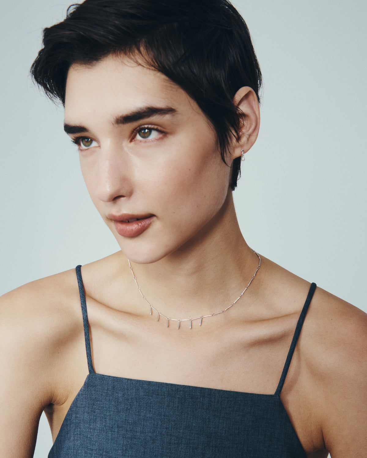 Stilla Necklace and Hydra Earrings in Silver, worn