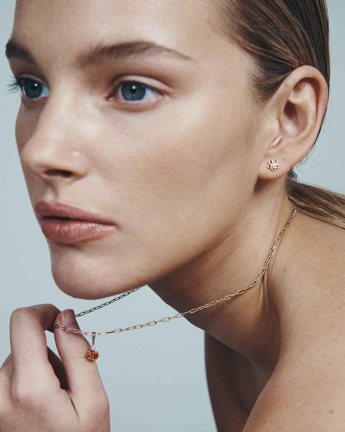 Astra Spessartite and Diamond Pendant with Daisy Ruby Earrings in solid gold, worn at the neck