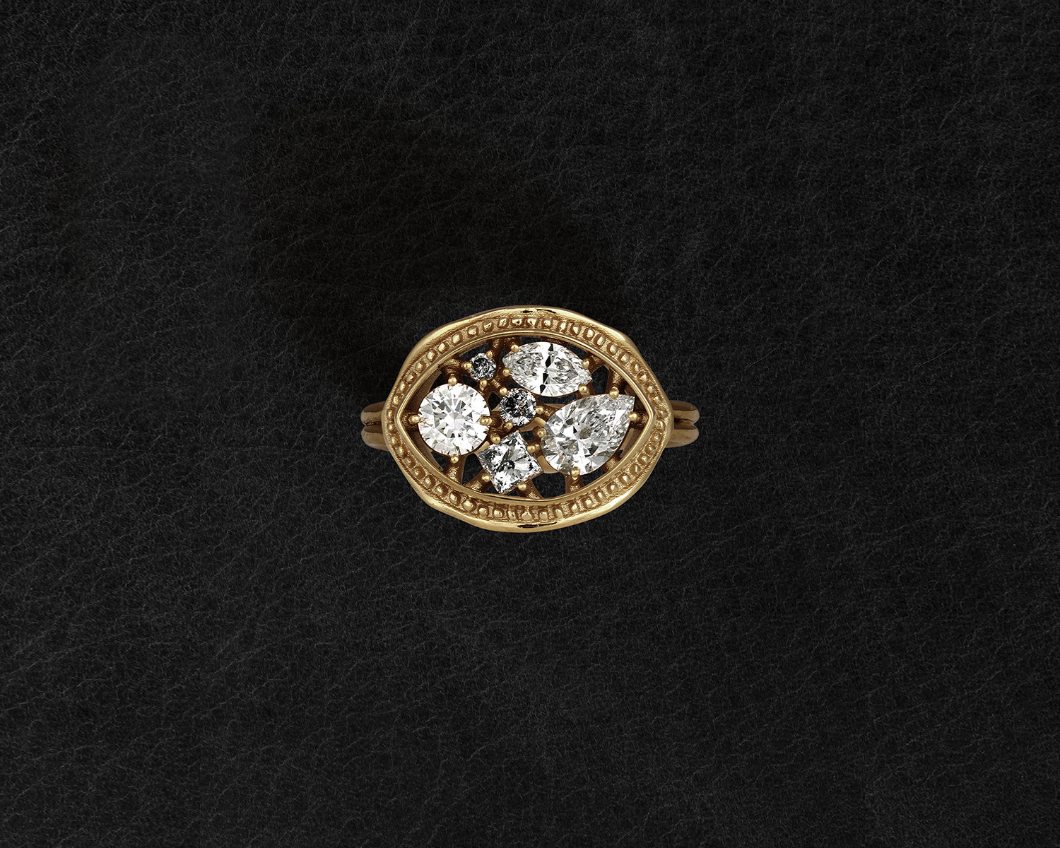 Gold ring with diamond accents on a black background