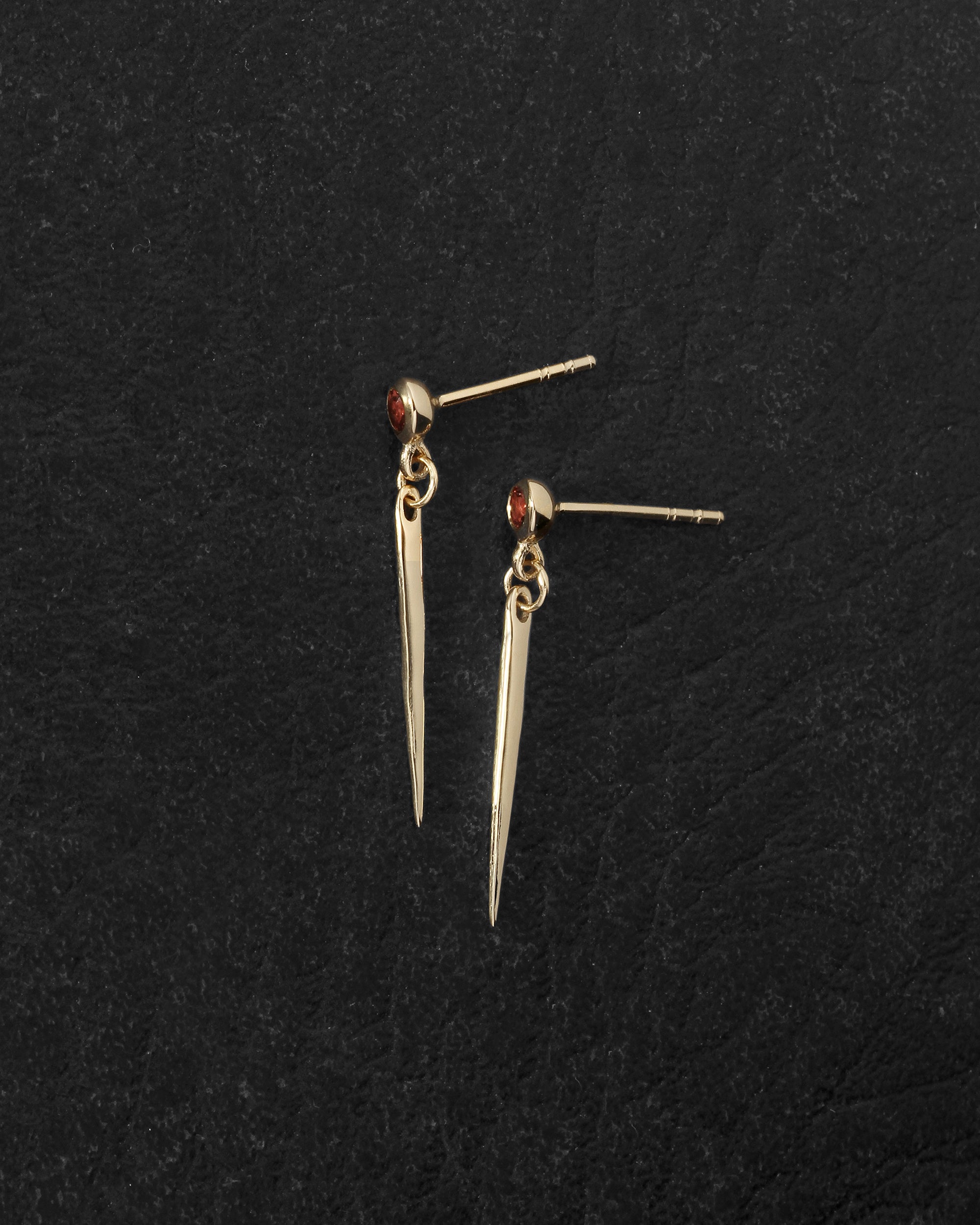 Cinder Earrings Gold Vermeil on dark leather