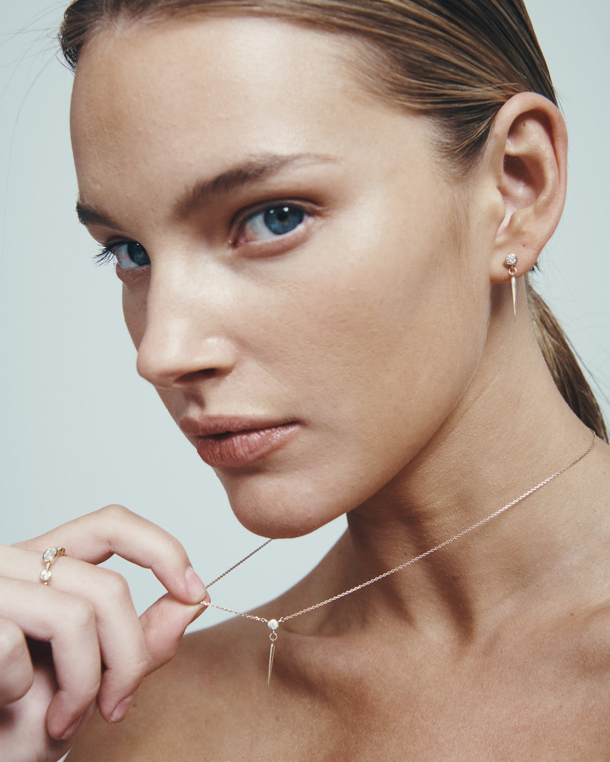 Comet Diamond Necklace and Comet Diamond Earrings in solid gold, worn