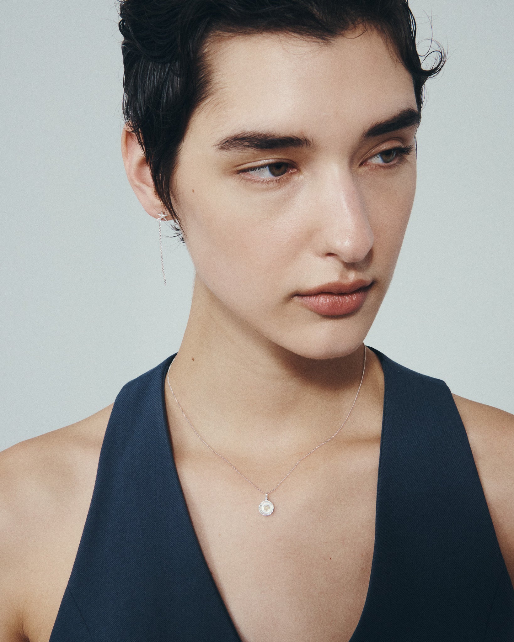 Seba Stud Earrings and Soma Coin Necklace in Silver, worn