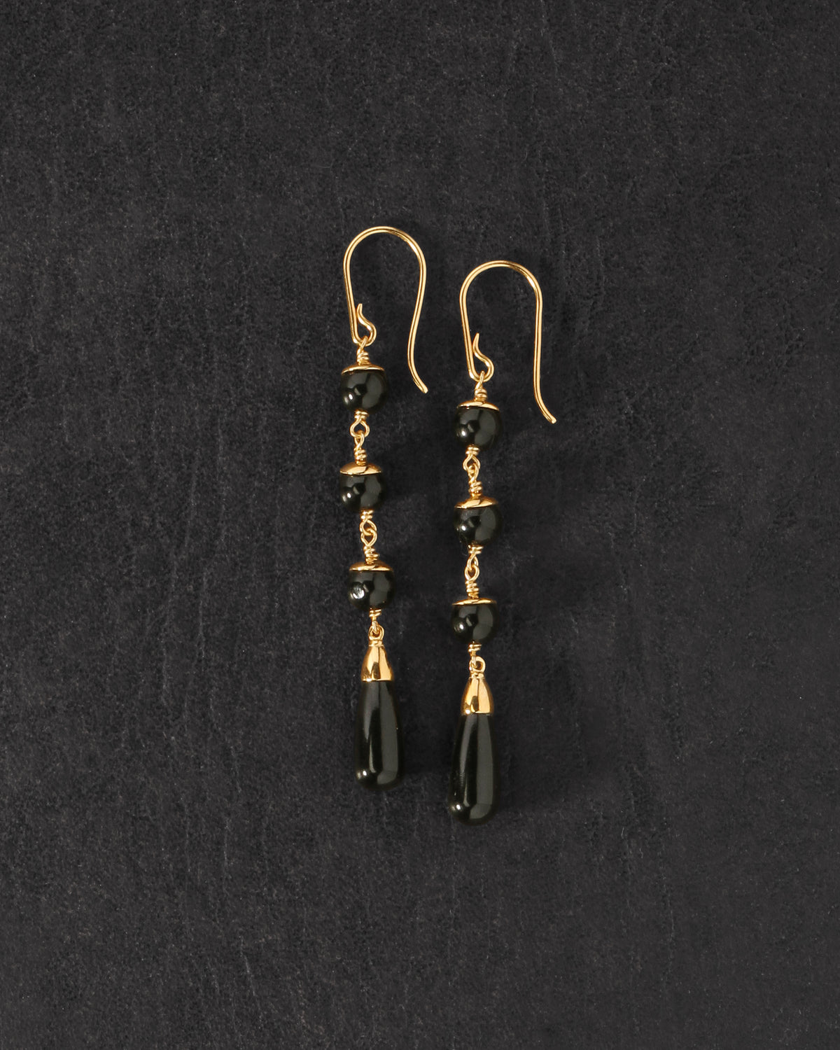 Sita Earrings Gold Vermeil on dark leather