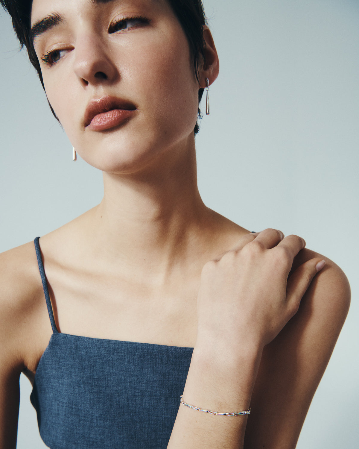 Stilla Earrings and Stilla Bracelet in Silver, worn