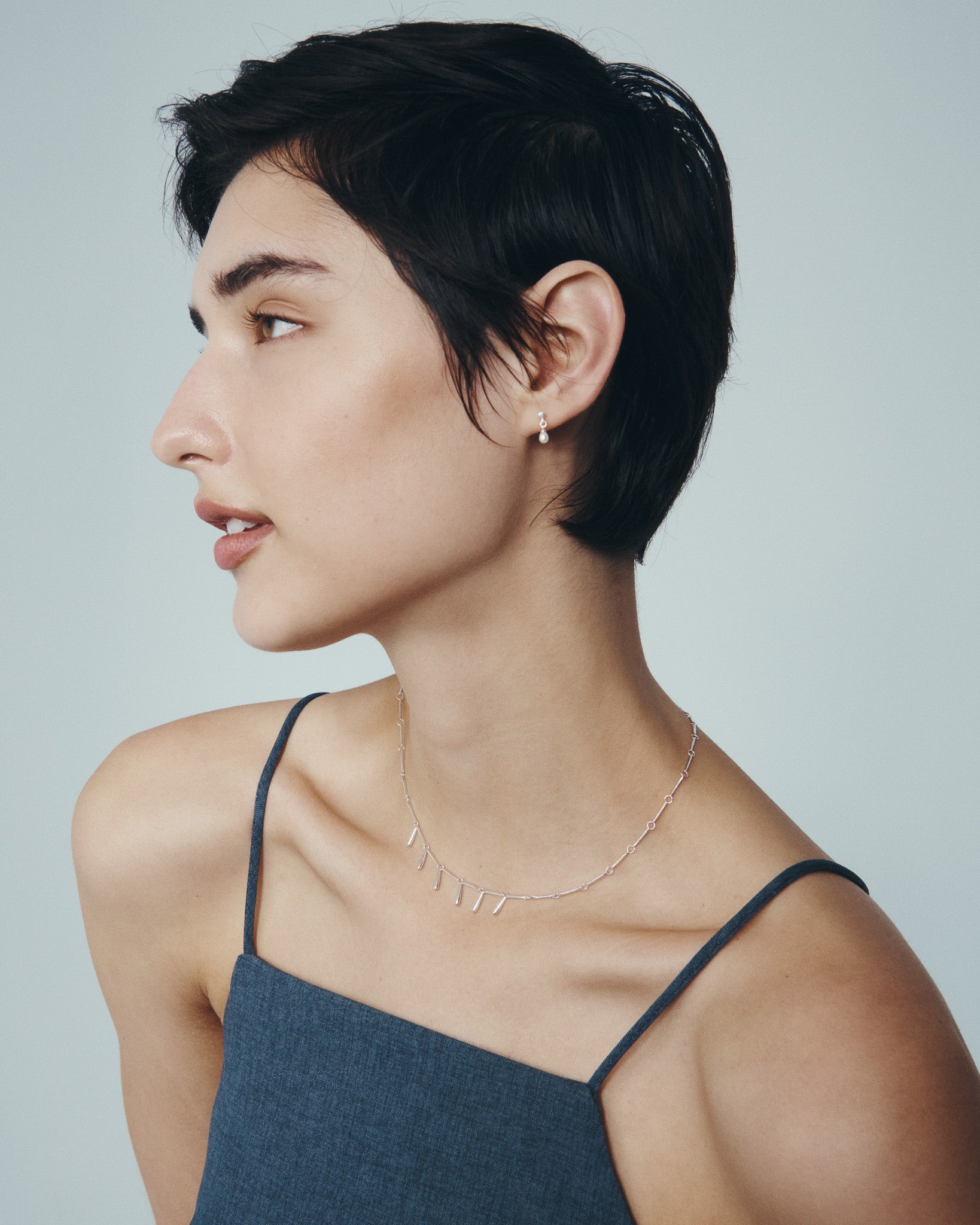 Stilla Necklace and Hydra Earrings in Silver, worn