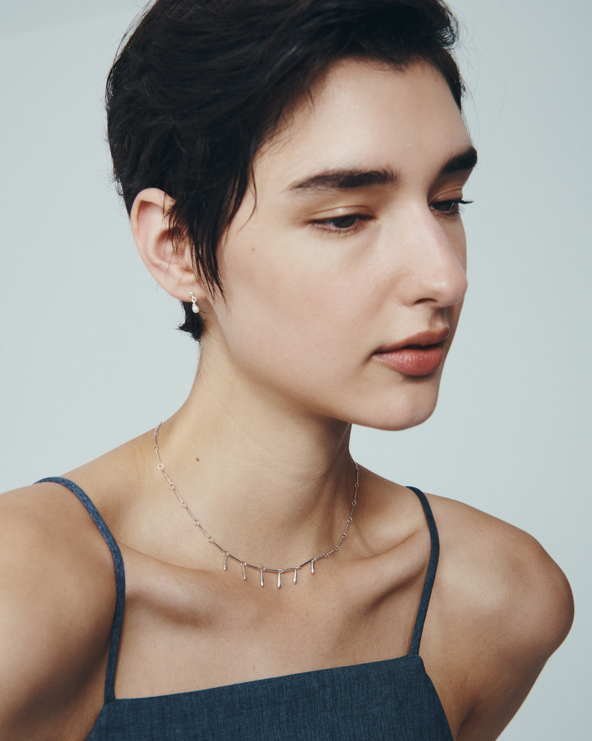 Stilla Necklace and Hydra Earrings in Silver, worn