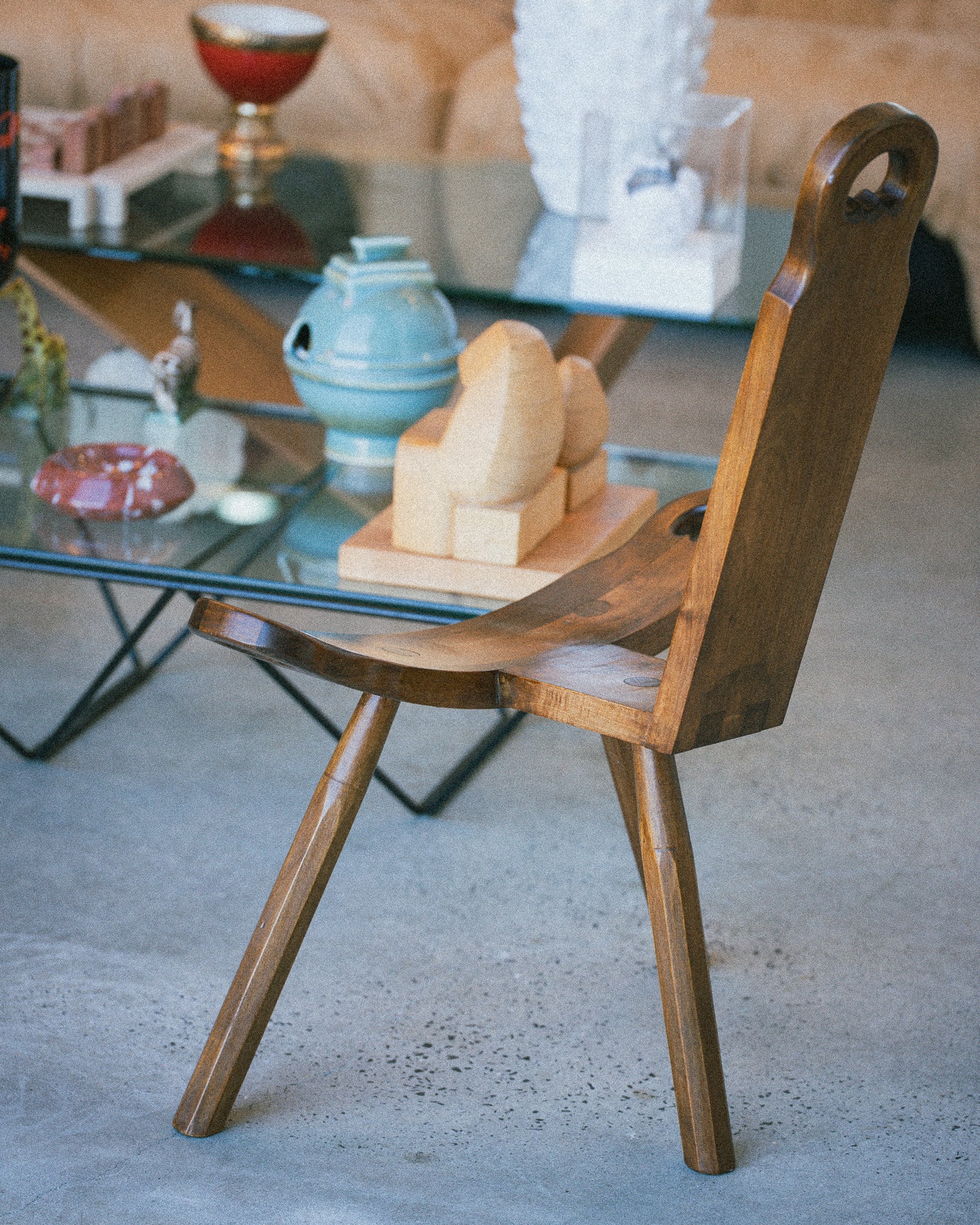 Wooden chair with a glass table in a room setting