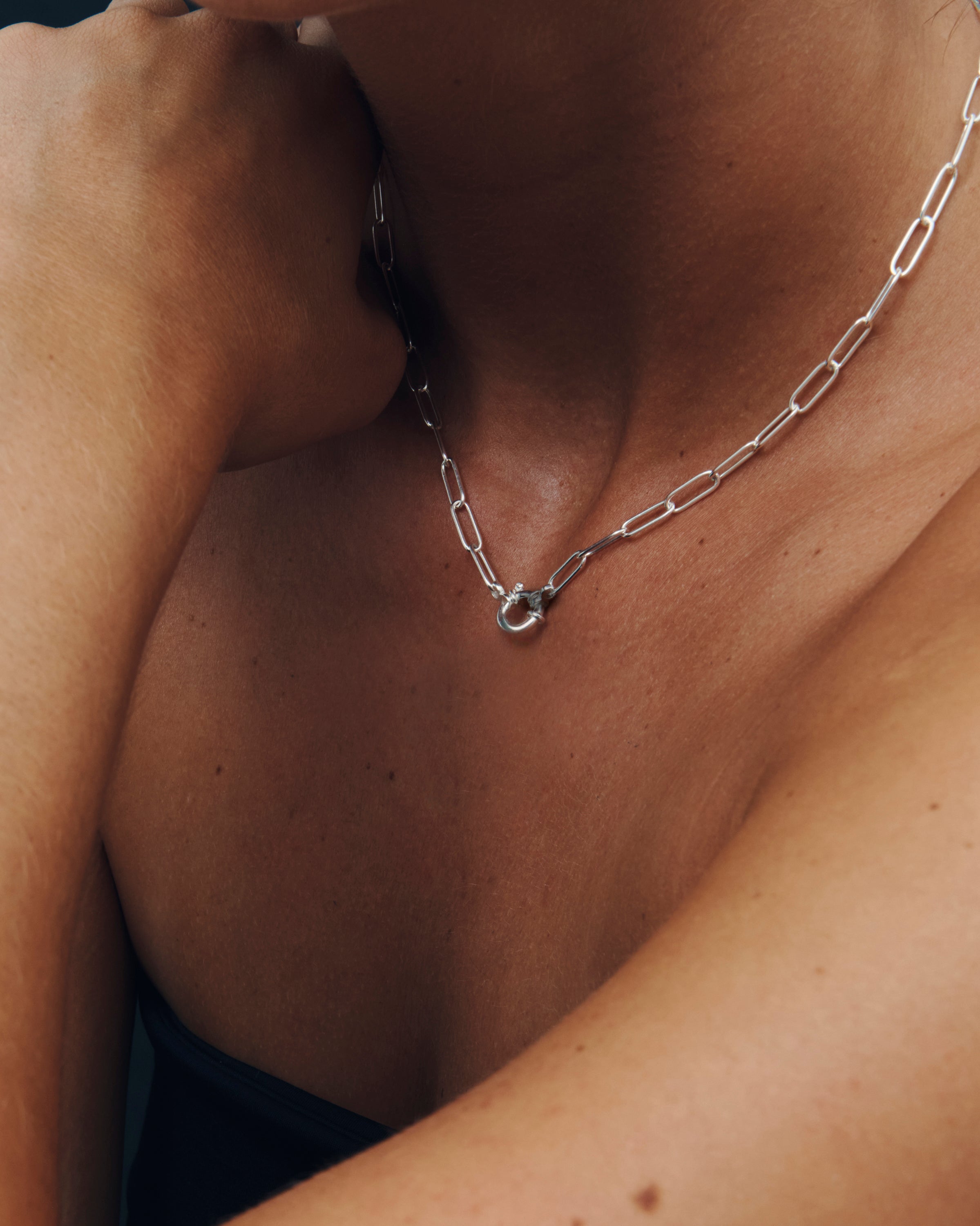 Close-up of a silver chain necklace on a person's neck